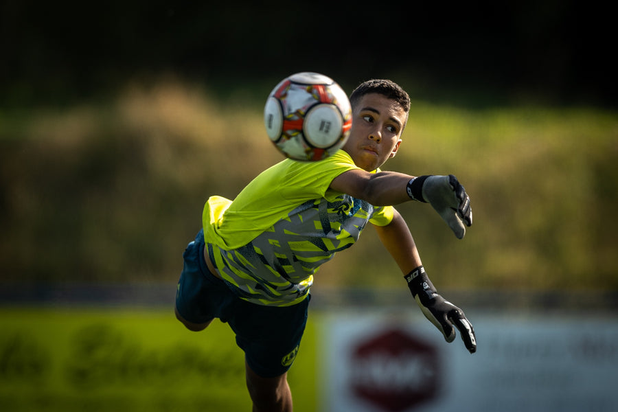 Goalkeeper diving to save a shot